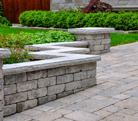 Brick divider along flowerbed.