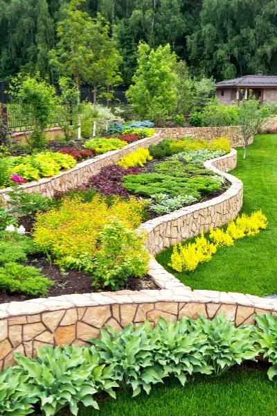 Colorful flowerbed garden lined with decorative stones.
