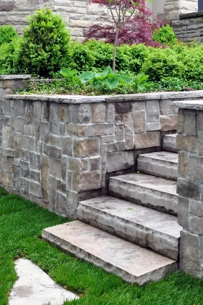 Flowerbed retainer wall made from stone.